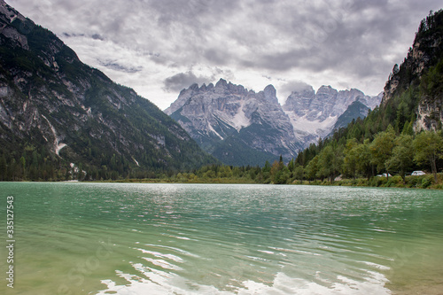 Italian Dolomites reflecting on the Cadore lake on a cloudy autumn day