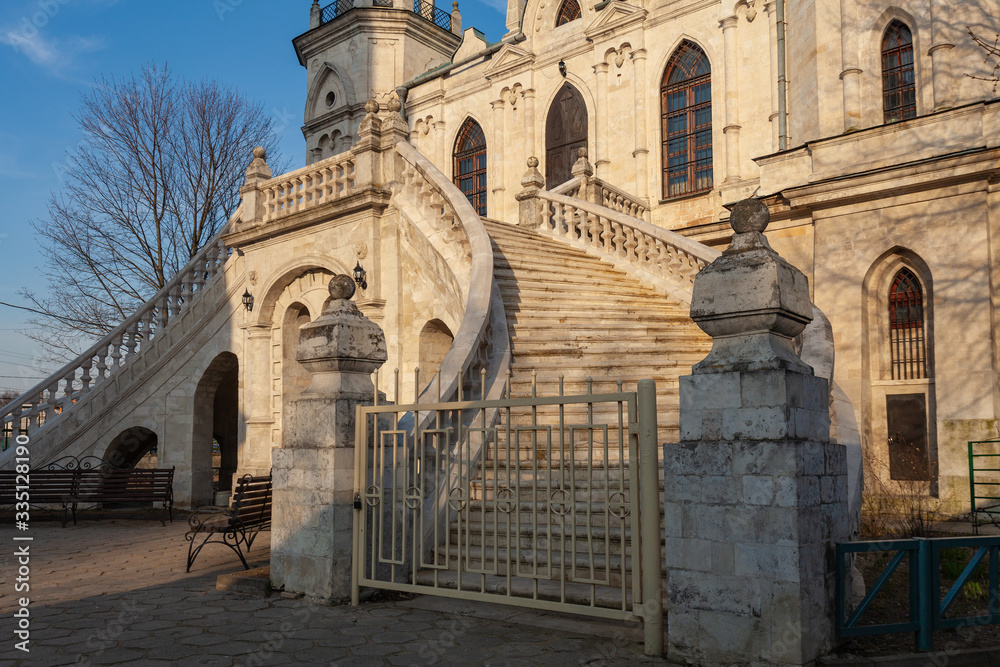 Fragment of the facade of an old Orthodox church with a picturesque arched staircase