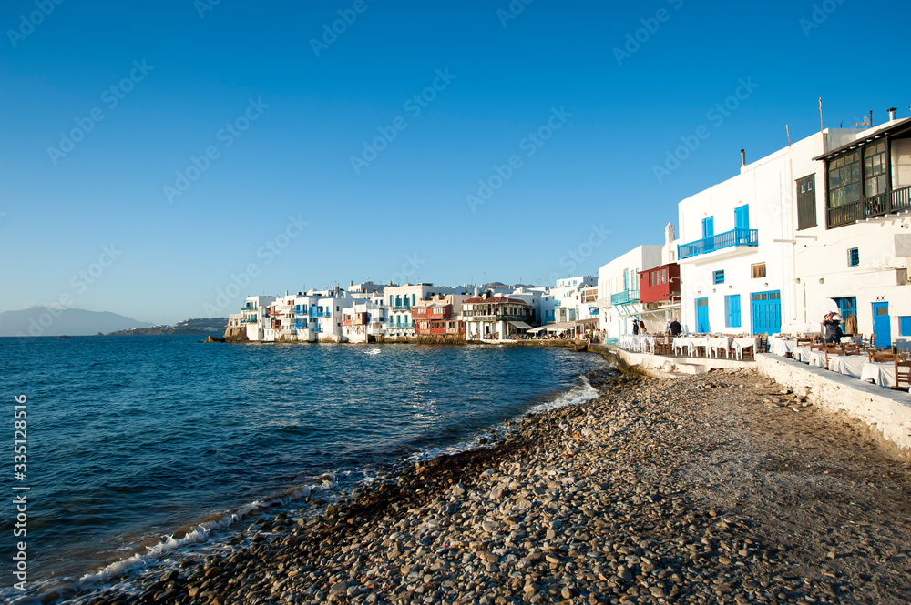 Bright scenic afternoon view of the colorful waterfront promenade of Mykonos Town, Greece