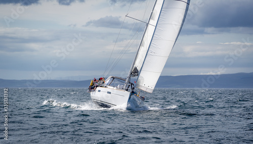 New sailing yacht going fast and beautiful directly on the camera. Sailing regatta in Scotland waters.