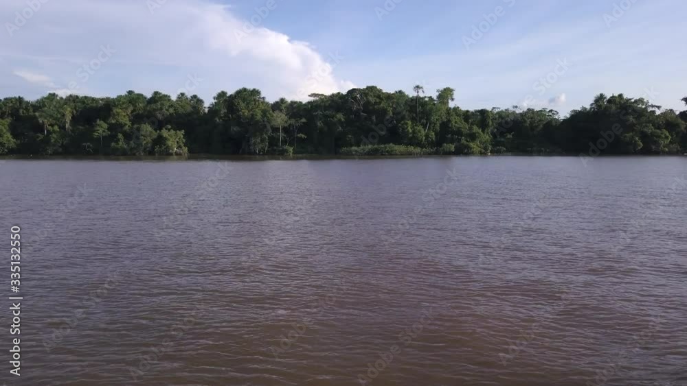 Beautiful view of the forest and Amazonas River through the window of a traditional wooden boat sailing during a trip in the Amazon rainforest. Concept of environment, ecology, travel and tourism. 4K. Beautiful view of the forest and Amazonas River through the window of a traditional wooden boat sailing during a trip in the Amazon rainforest. Concept of environment, ecology, travel and tourism. 4K.
