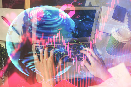 Double exposure of woman hands typing on computer and business theme hologram drawing. Success concept.