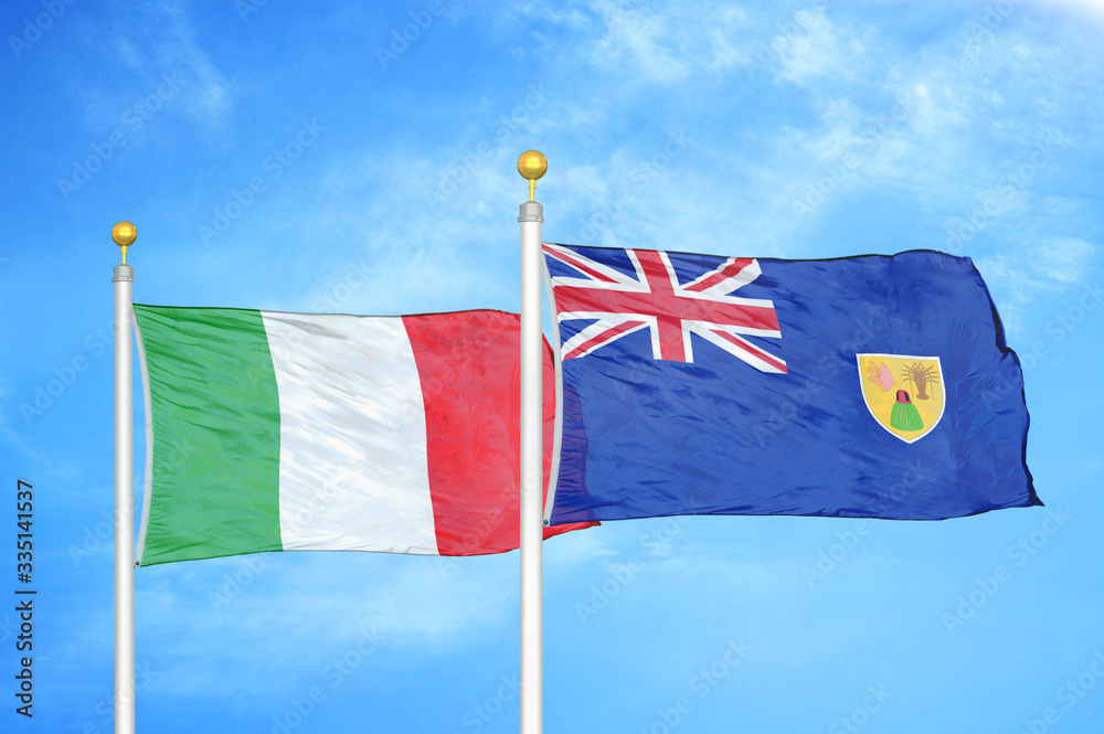 Fototapeta premium Italy and Turks and Caicos Islands two flags on flagpoles and blue cloudy sky