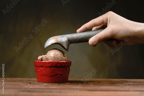 Scoop of ice cream dropped in a bowl.