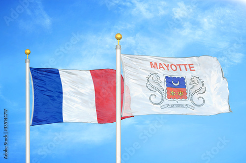 France and Mayotte two flags on flagpoles and blue cloudy sky photo