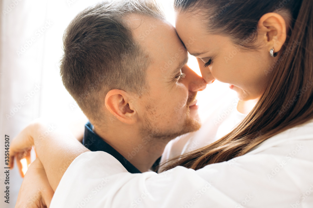 Close-up photo of a hugging couple in love, indoors Close-up photo of a hugging couple in love, indoors