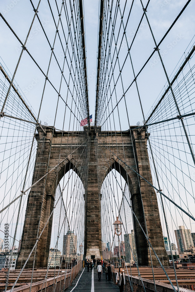 Fototapeta premium Vertical view of one of the Brooklyn Bridge pillars from the pedestrian path. Manhattan