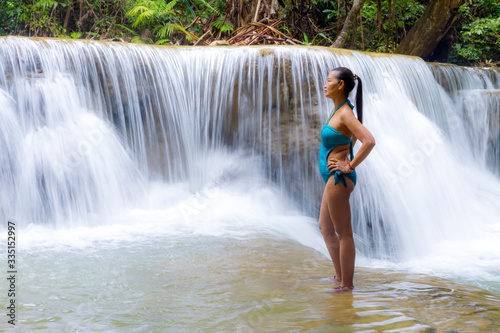 Woman in swimsuit stand at Huai Mae Khamin waterfall and natural
