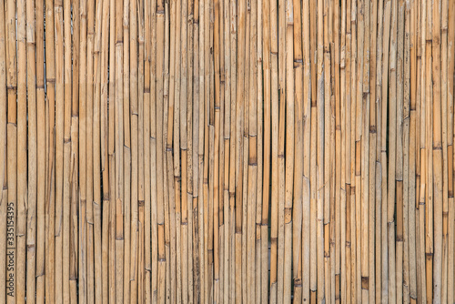 Old brown bamboo background. Wall of bamboo. Rural rustic background