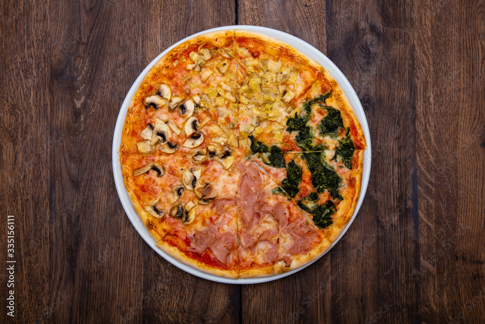 Classic Italian pizza on a wooden table Classic Italian pizza on a wooden table