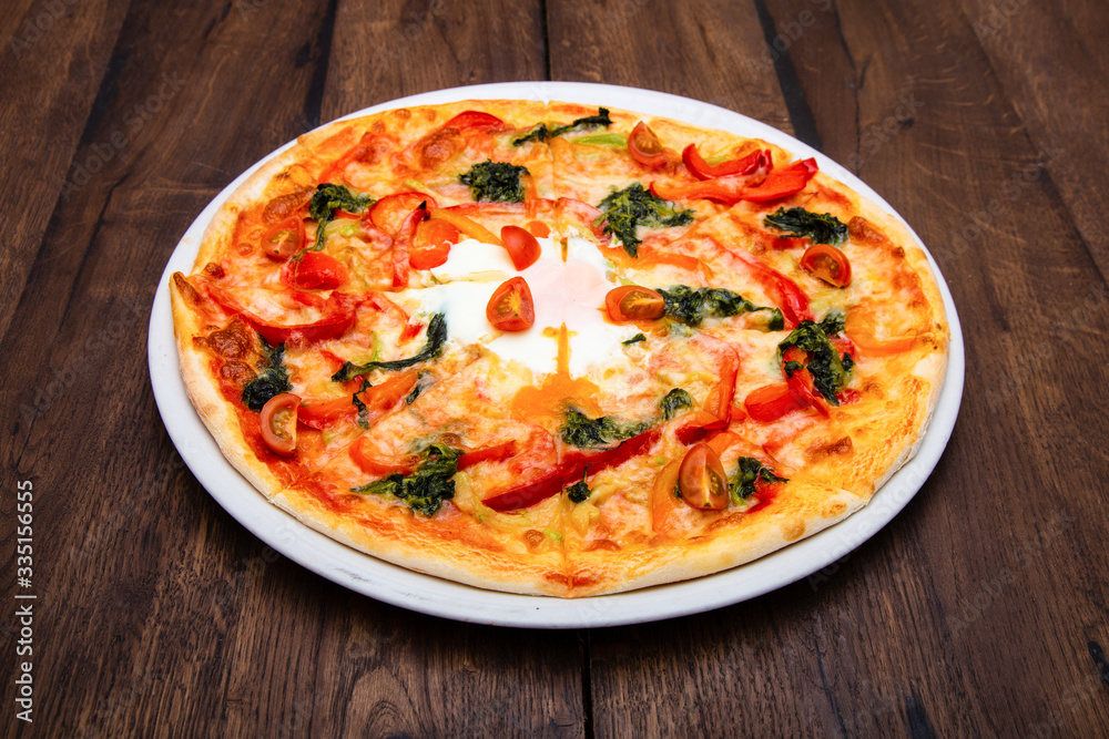 Classic Italian pizza on a wooden table Classic Italian pizza on a wooden table
