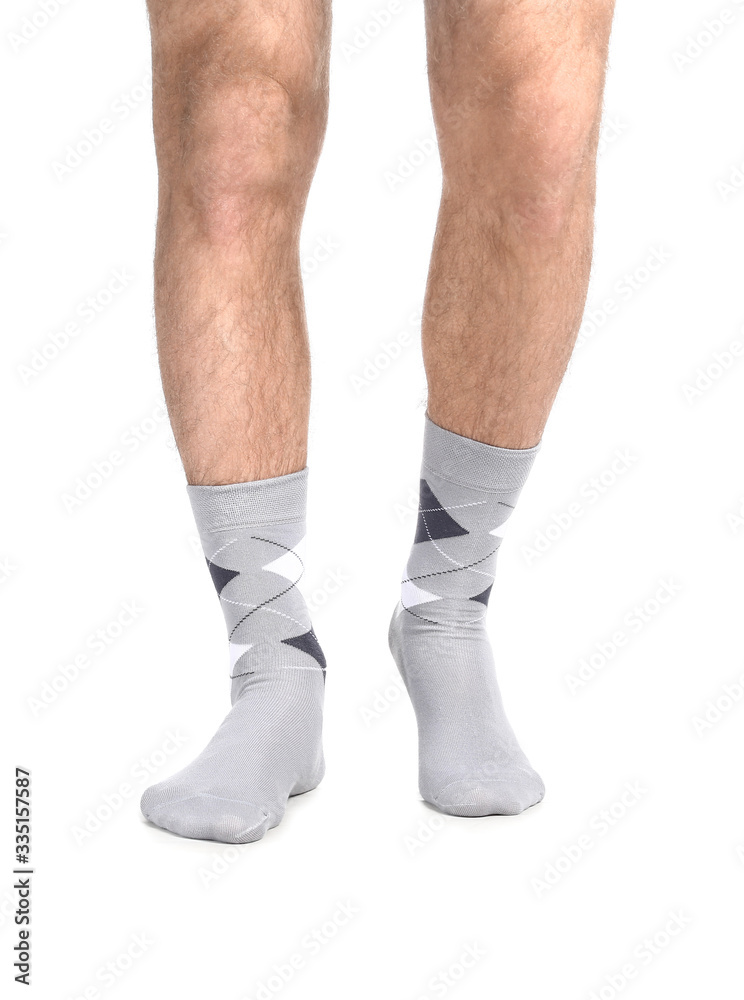 Male legs in socks on white background