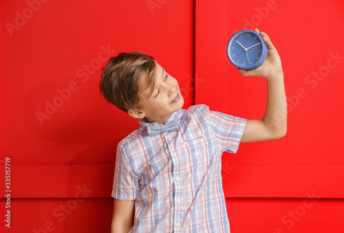 Little boy with alarm clock...