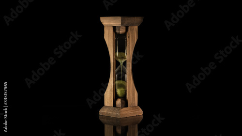 Wooden hourglass with green sand
