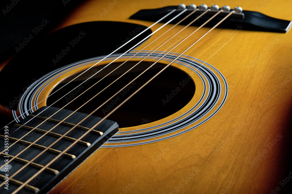 Yellow wood body with slight blurring of the strings and neck. Yellow wood body with slight blurring of the strings and neck.