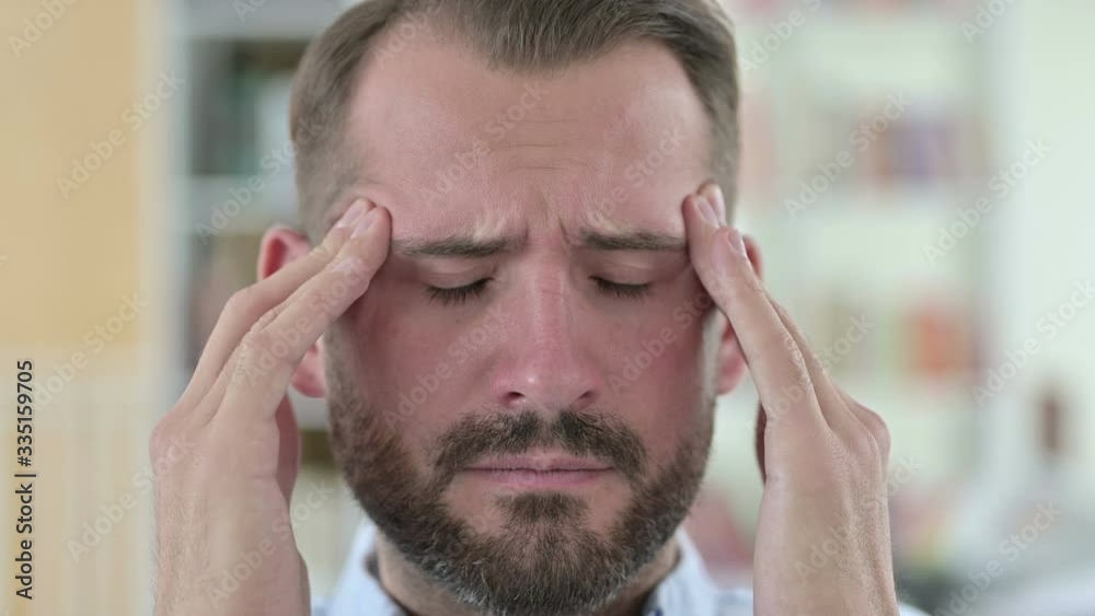 Close Up of Stressed Young Man with Headache Close Up of Stressed Young Man with Headache