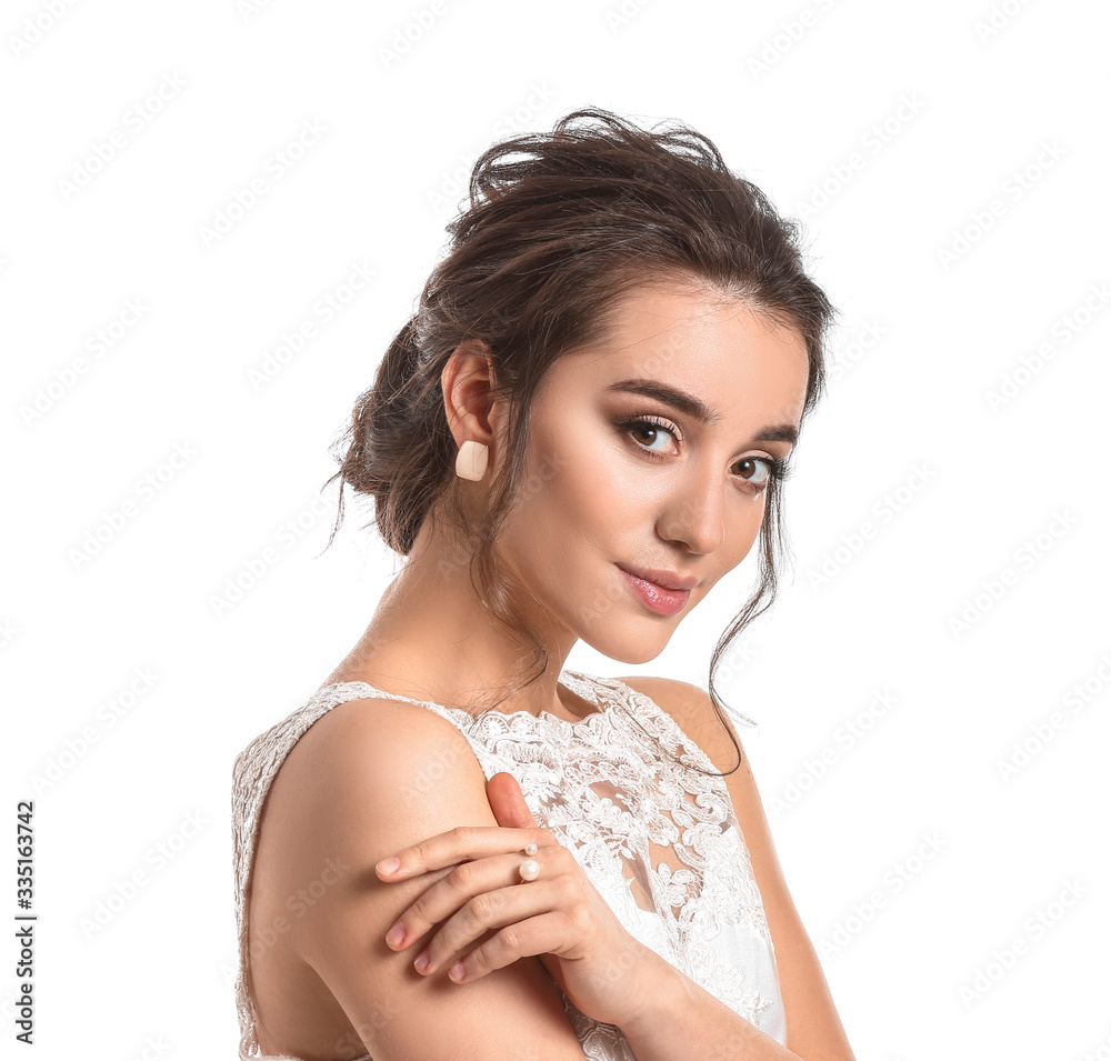 Young bride with beautiful hairdo on white background