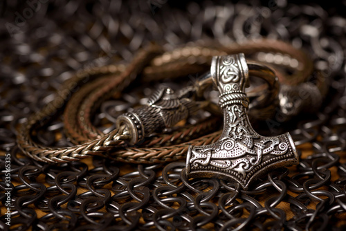 Thor's silver Hammer pendant on the chain, steel chain mail and Viking helmet. Handmade. Mjolnir. Viking's symbol.
