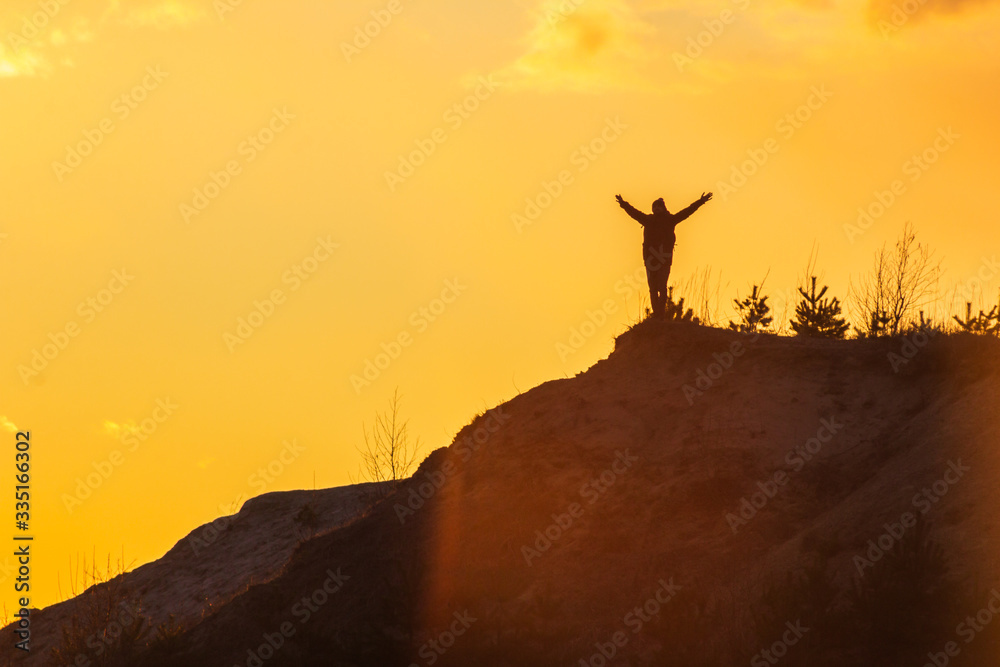man at the top of the mountain at sunset success