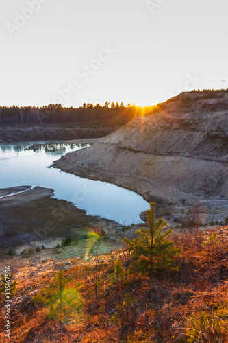 sunset over the sandy cliffs and lake landscape