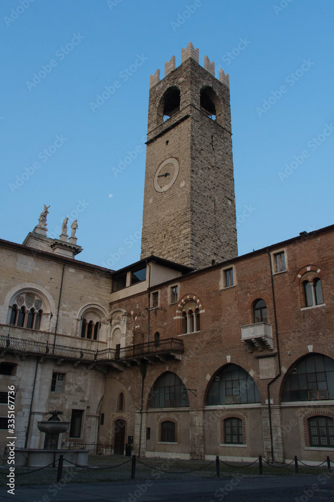 Inner yard of medieval palace Palazzo del Broletto with Tower of Pegol on background, Brescia, Lombardy, Italy. Inner yard of medieval palace Palazzo del Broletto with Tower of Pegol on background, Brescia, Lombardy, Italy.