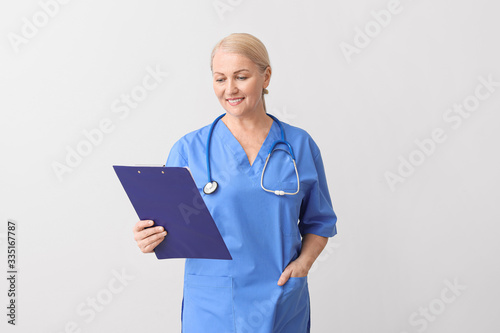 Mature female doctor on lig...