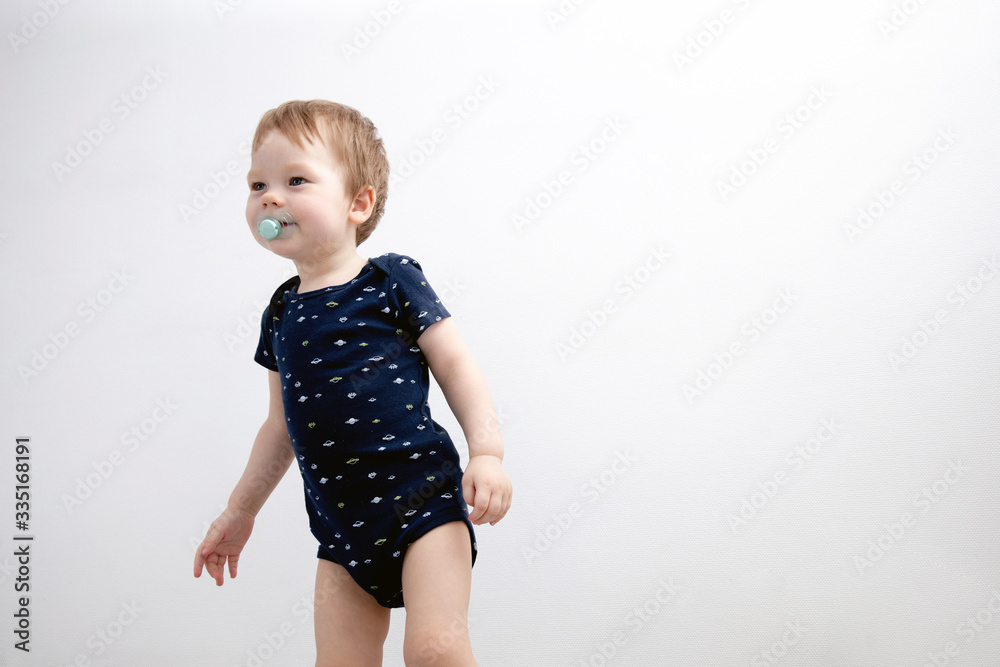Portrait of boy child standing next to white wall. Lifestyle photo Portrait of boy child standing next to white wall. Lifestyle photo