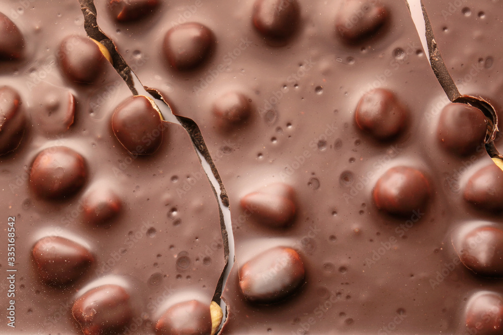 Fototapeta premium Sweet chocolate with nuts as background
