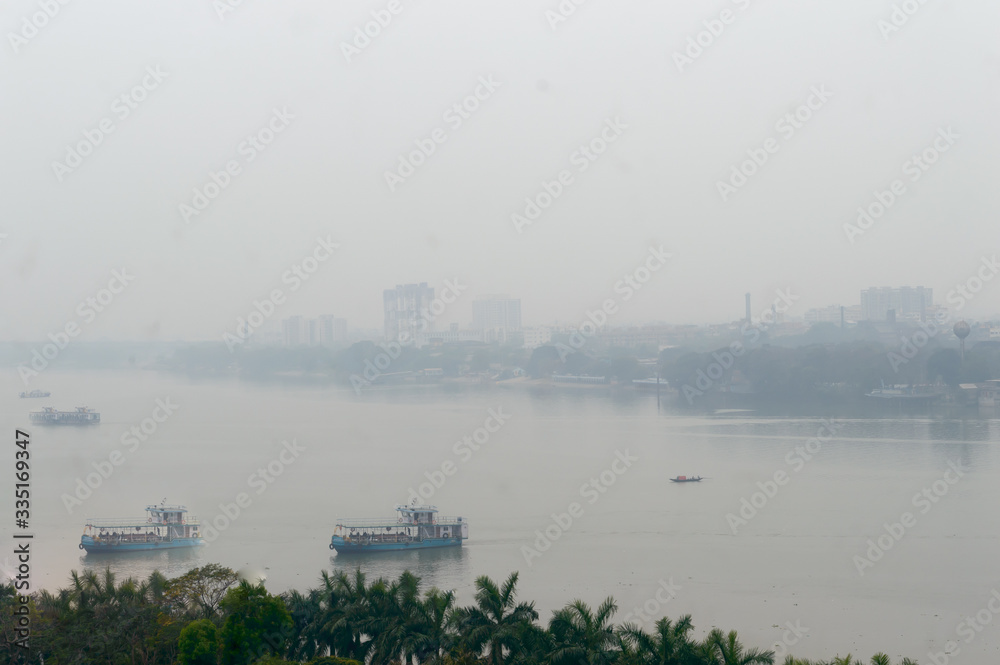 Panoramic Kolkata riverside city life in a winner foggy evening. Ariel view Kolkata in Hooghly riverbank West Bengal India South Asia Pacific. Photography from rooftop.