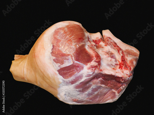 Raw pork knuckle on a black background