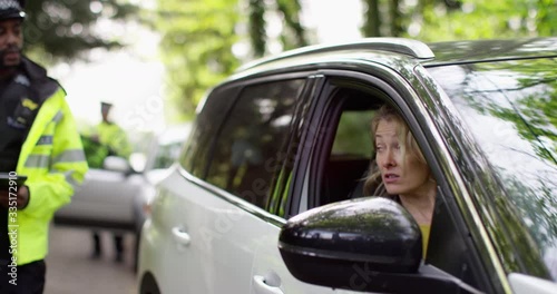 4K Driver with guilty expression & bad attitude being questioned by traffic cop. Slow motion.