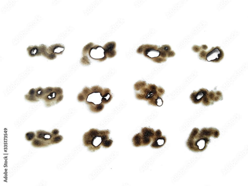 Collection of burnt holes in a piece of paper isolated on white background. Fire holes in white paper. Collection of burnt holes in a piece of paper isolated on white background. Fire holes in white paper.