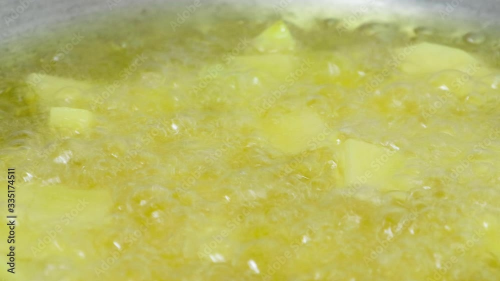 Deep frying potato cubes in a frying pan Deep frying potato cubes in a frying pan