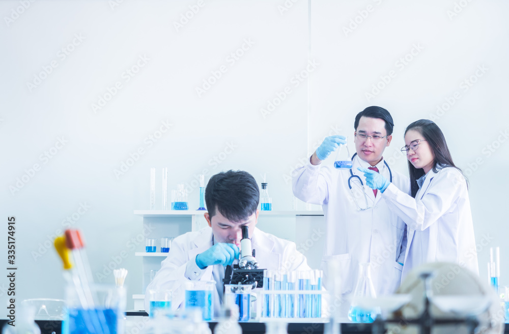Scientist Looking Through Microscope In Laboratory, Scientist Looking Through Microscope In Laboratory,