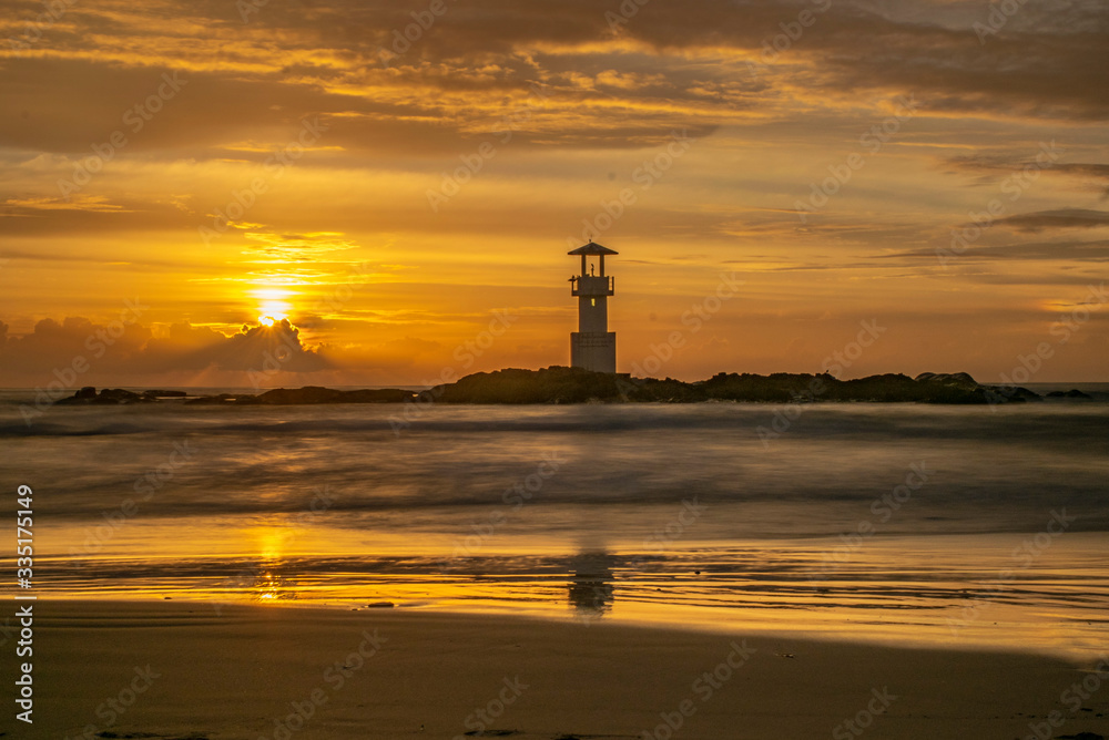 sunset lighthouse on the beach