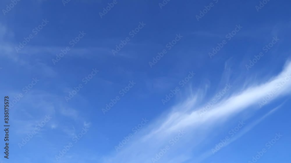 Circus or cirrostratus clouds slowly move on clear blue sky TimeLapse. Abstract nature background of cirrocumulus cloudscape on beautiful wispy indigo sky in summer sunlight at sunny sunshine day Circus or cirrostratus clouds slowly move on clear blue sky TimeLapse. Abstract nature background of cirrocumulus cloudscape on beautiful wispy indigo sky in summer sunlight at sunny sunshine day