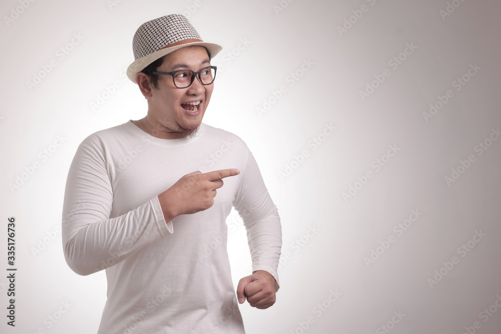 Young Man Showing and Pointing Something on His Side Young Man Showing and Pointing Something on His Side