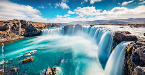 Sunny summer scene of Skjalfandafljot river  Iceland  Europe. Panoramic morning view of Godafoss  spectacular waterfall plunging over a curved  12m-high precipice  with paths to various viewpoints.