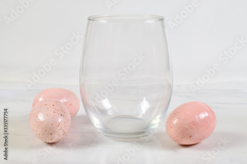 Easter inpired stemless wine glass mockup with colorful eggs photo