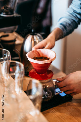 preparing a pourover (v60) in coffeeshop