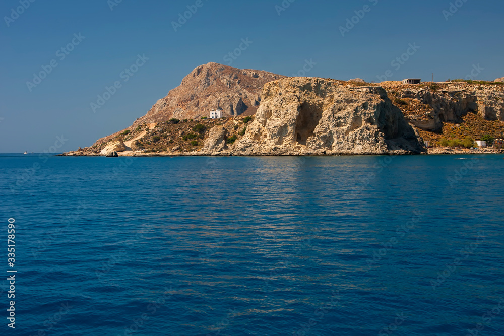 Beautiful stone mountain on the shore of the blue sea