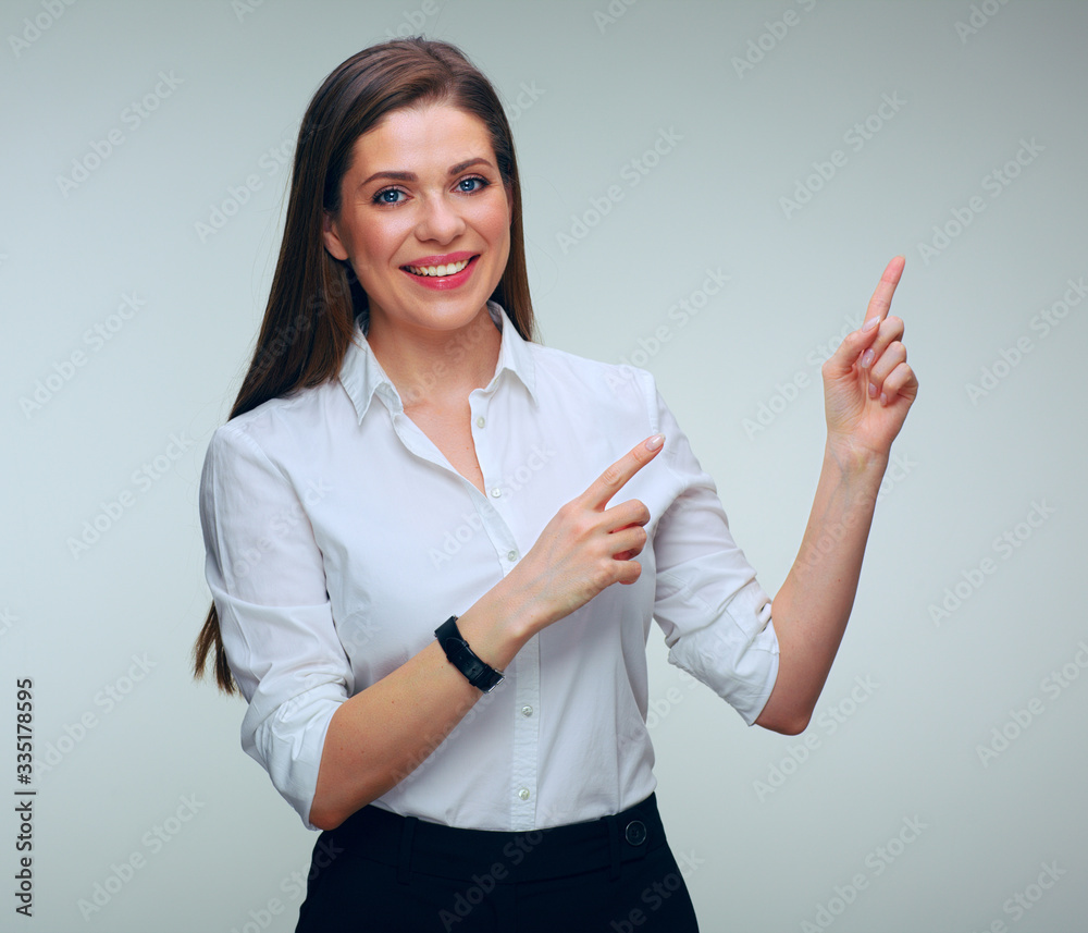Smiling business woman pointing finger up. Smiling business woman pointing finger up.