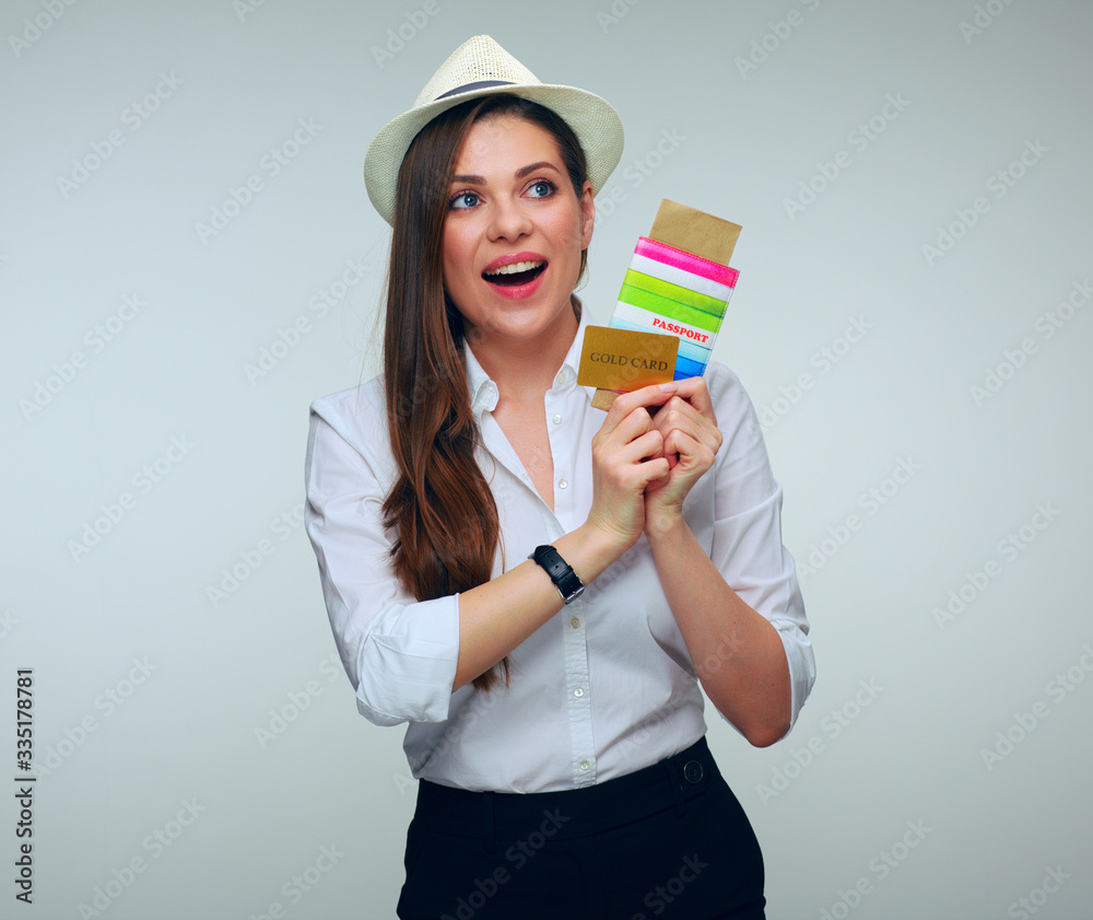 Young woman traveller holding credit card and looking away. Young woman traveller holding credit card and looking away.