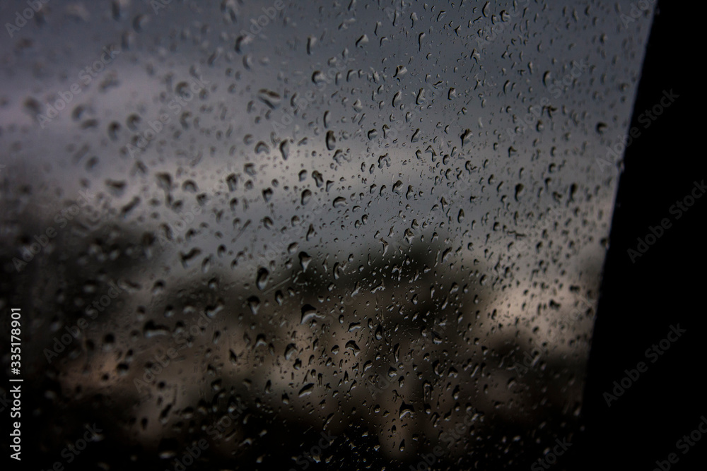 Splashing on glass against a gloomy gray sky