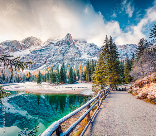 Fantastic autumn view of Braies Lake. First snow in mountains. Colorful morning sunrise of Dolomite Alps, Naturpark Fanes-Sennes-Prags, Italy, Europe. Beauty of nature concept background.