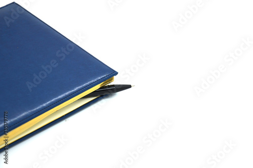 blank blue leather diary on white desk © Alena