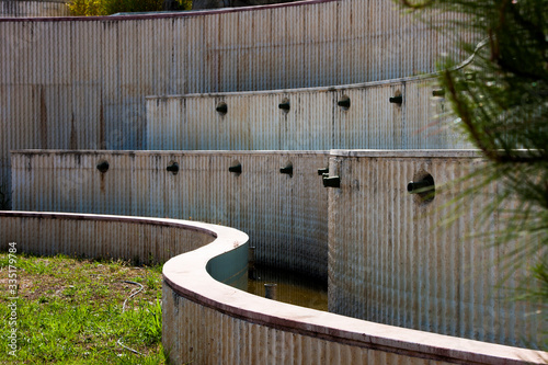 A winding wall near an abandoned pool