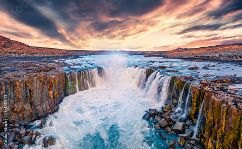 View from flying drone of Selfoss Waterfall. Awesome summer sunrise on Jokulsa a Fjollum river, Jokulsargljufur National Park. Colorful morning scene of Iceland, Europe.