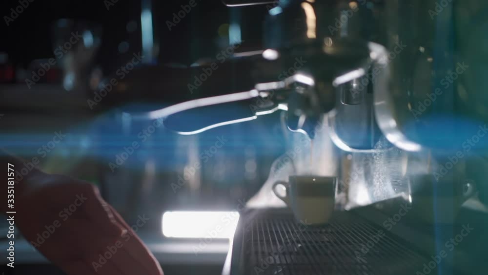barista make hot black espresso in coffee machine