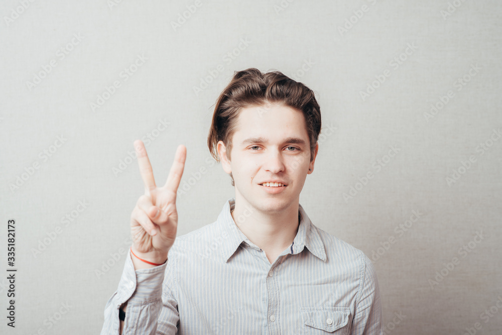 young man showing two fingers young man showing two fingers
